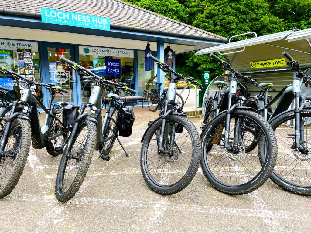 Image showing a row of electric mountain bikes available for hire at the Loch Ness Hub.